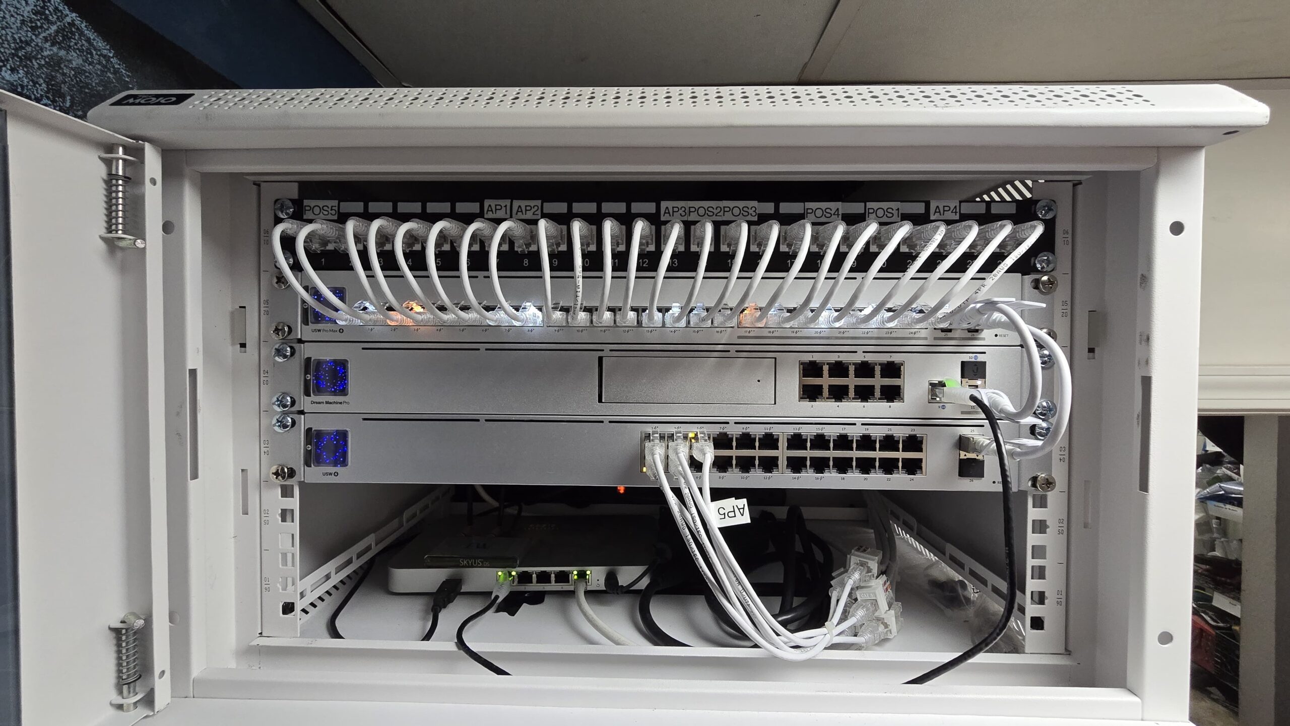 Starlight Cabling installed UniFi network rack with structured patch panels and organized cables